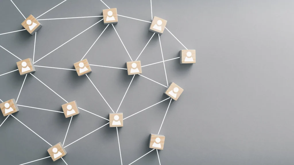 Wooden cubes connected with white lines illustrating network expansion through strategic Link Building Packages Prices.
